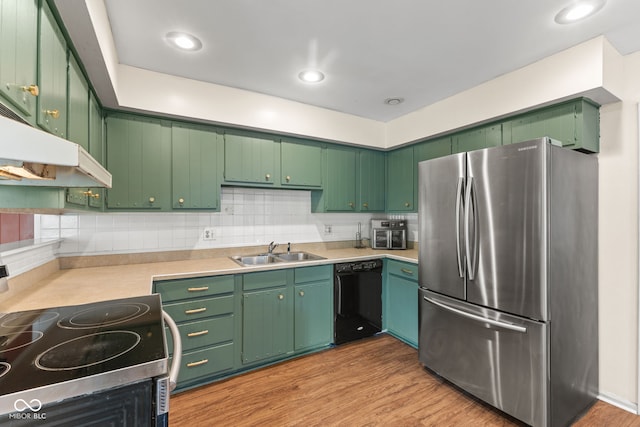 308 Hickory Hill Dr, Terre Haute, IN 47802 - kitchen with freestanding refrigerator, black dishwasher, electric range, a sink, and under cabinet range hood