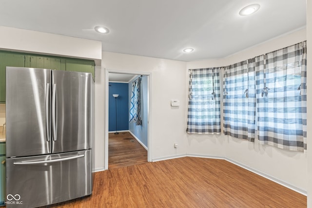 308 Hickory Hill Dr, Terre Haute, IN 47802 - kitchen featuring freestanding refrigerator, green cabinetry, wood finished floors, baseboards, and recessed lighting