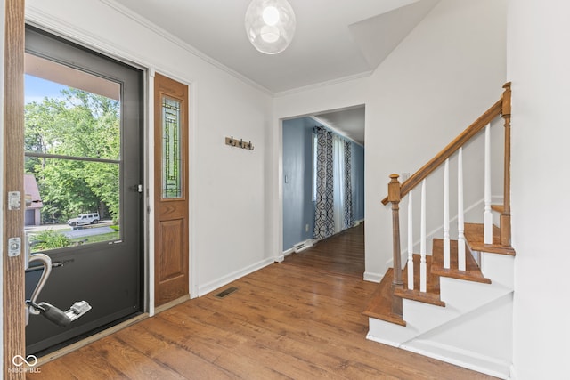 308 Hickory Hill Dr, Terre Haute, IN 47802 - foyer featuring wood finished floors, crown molding, stairway, and baseboards