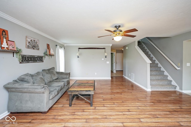11198 N 650 W, Fountaintown, IN 46130 - living area with ceiling fan, light wood-style floors, stairs, baseboards, and crown molding