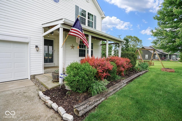 11198 N 650 W, Fountaintown, IN 46130 - property entrance with a lawn, a garage, and a porch