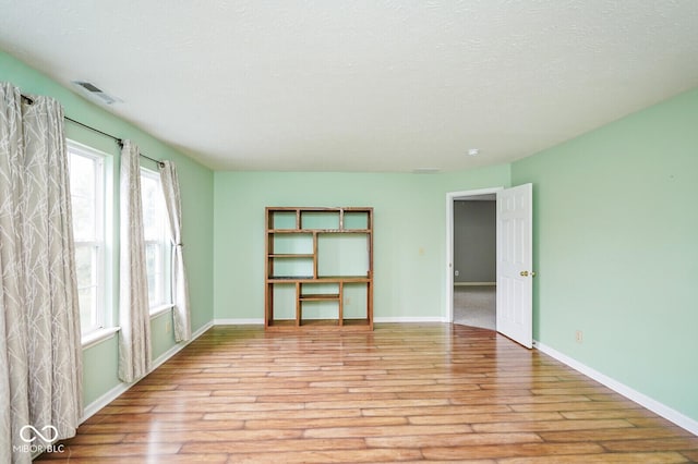 11198 N 650 W, Fountaintown, IN 46130 - unfurnished room with light wood-style floors, plenty of natural light, baseboards, and a textured ceiling