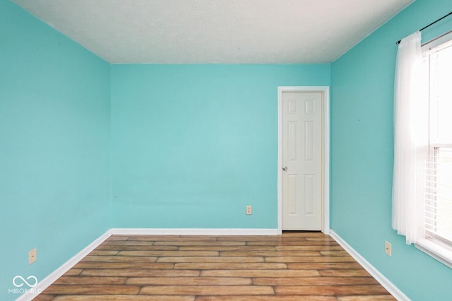 11198 N 650 W, Fountaintown, IN 46130 - spare room with wood finished floors, baseboards, and plenty of natural light