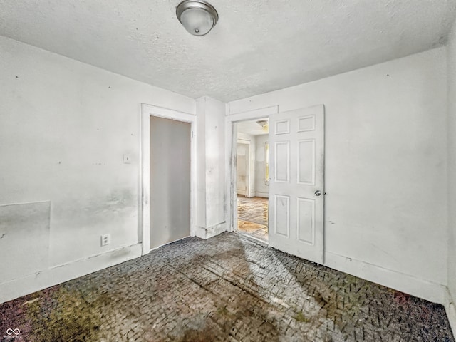 3526 E Vermont St, Indianapolis, IN 46201 - unfurnished bedroom with a textured ceiling