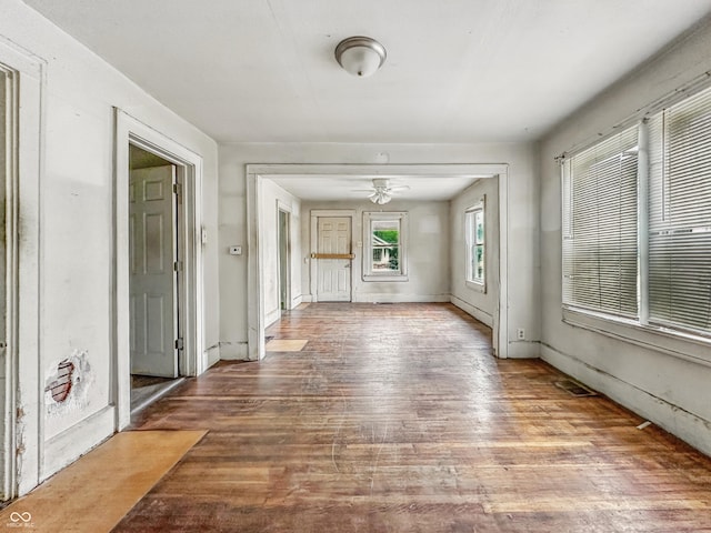 3526 E Vermont St, Indianapolis, IN 46201 - unfurnished living room with wood finished floors, a ceiling fan, and baseboards