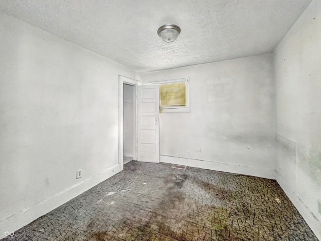 3526 E Vermont St, Indianapolis, IN 46201 - unfurnished room featuring a textured ceiling and baseboards