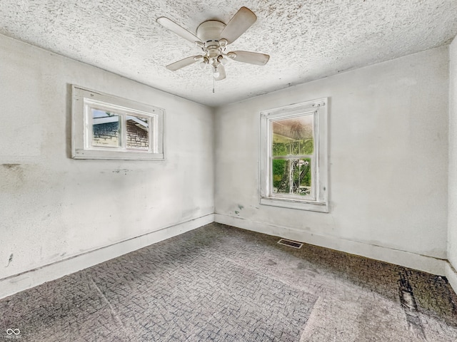 3526 E Vermont St, Indianapolis, IN 46201 - empty room with dark colored carpet, a textured ceiling, and a ceiling fan