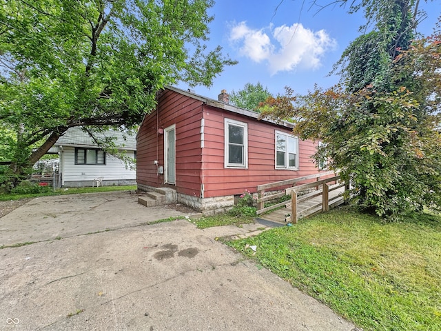 3526 E Vermont St, Indianapolis, IN 46201 - view of side of home with a chimney and entry steps