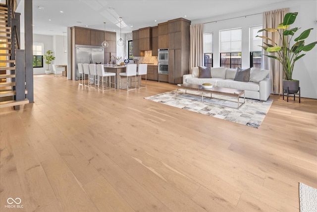 1818 N Pennsylvania St, Indianapolis, IN 46202 - living area featuring light wood-type flooring, stairs, and recessed lighting