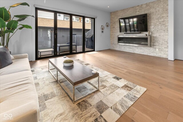 1818 N Pennsylvania St, Indianapolis, IN 46202 - living room featuring wood finished floors, a glass covered fireplace, and recessed lighting