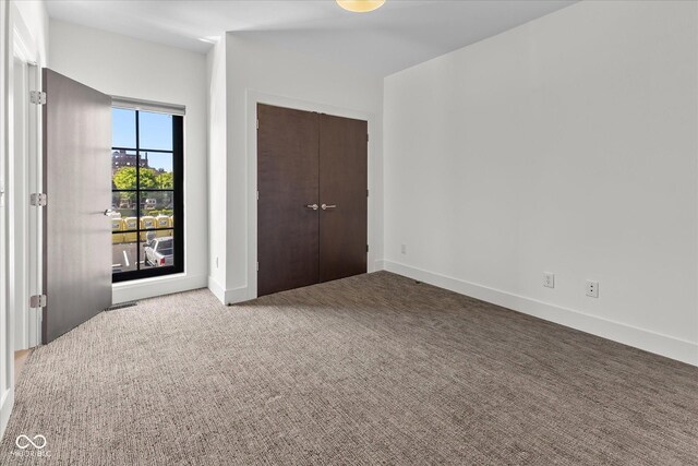 1818 N Pennsylvania St, Indianapolis, IN 46202 - unfurnished bedroom featuring carpet floors, a closet, and baseboards