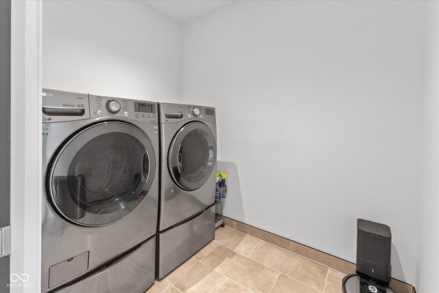 1818 N Pennsylvania St, Indianapolis, IN 46202 - washroom with separate washer and dryer, light tile patterned flooring, and baseboards