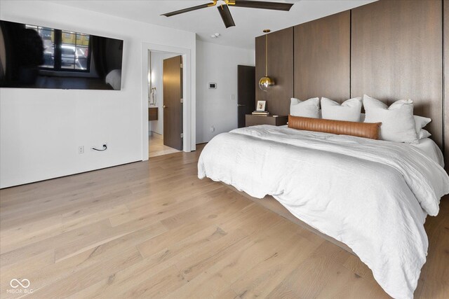 1818 N Pennsylvania St, Indianapolis, IN 46202 - bedroom with light wood finished floors, ceiling fan, and connected bathroom