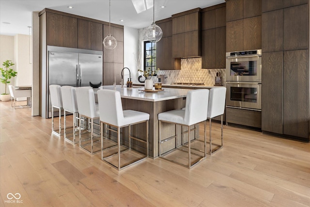 1818 N Pennsylvania St, Indianapolis, IN 46202 - kitchen with stainless steel appliances, modern cabinets, a kitchen bar, and recessed lighting