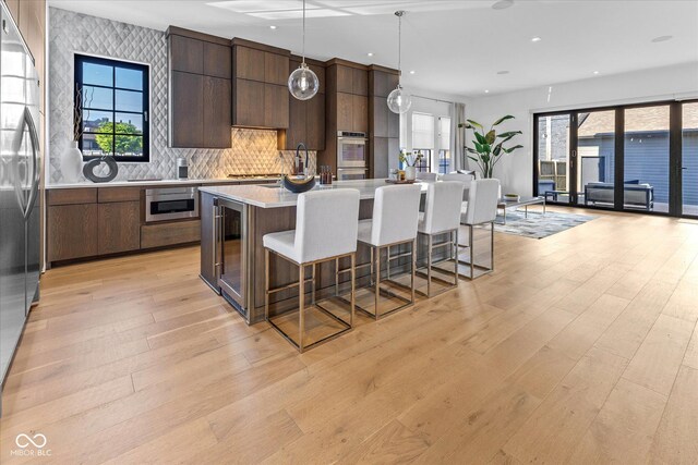 1818 N Pennsylvania St, Indianapolis, IN 46202 - kitchen with modern cabinets, stainless steel appliances, light countertops, recessed lighting, and light wood-style floors