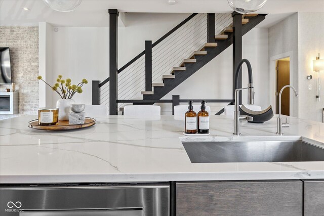 1818 N Pennsylvania St, Indianapolis, IN 46202 - kitchen featuring a sink, dishwasher, and light stone countertops