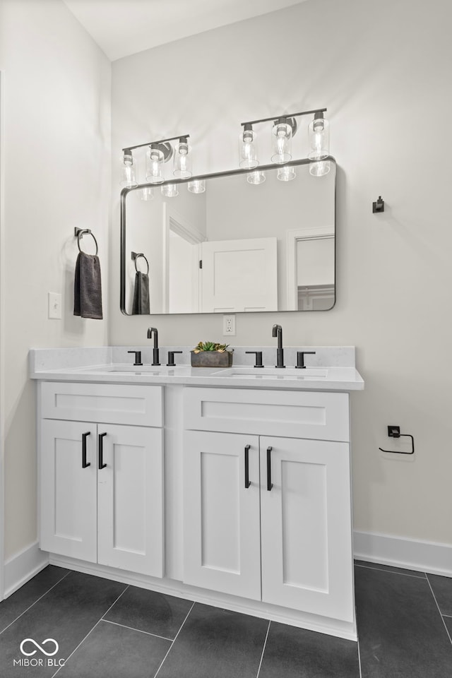 1405 Deloss St, Indianapolis, IN 46201 - bathroom featuring double vanity, tile patterned flooring, and baseboards