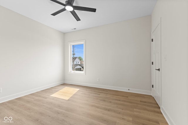1405 Deloss St, Indianapolis, IN 46201 - empty room with a ceiling fan, light wood finished floors, and baseboards