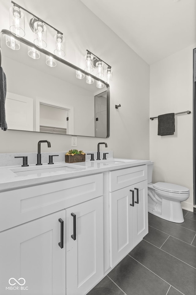 1405 Deloss St, Indianapolis, IN 46201 - full bathroom with double vanity, tile patterned floors, and toilet