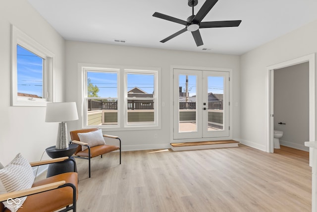1405 Deloss St, Indianapolis, IN 46201 - sitting room featuring light wood-type flooring, healthy amount of natural light, ceiling fan, and baseboards