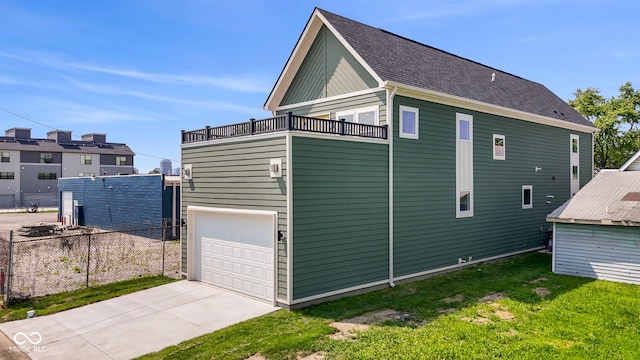 1405 Deloss St, Indianapolis, IN 46201 - view of home's exterior featuring a balcony, an attached garage, and concrete driveway