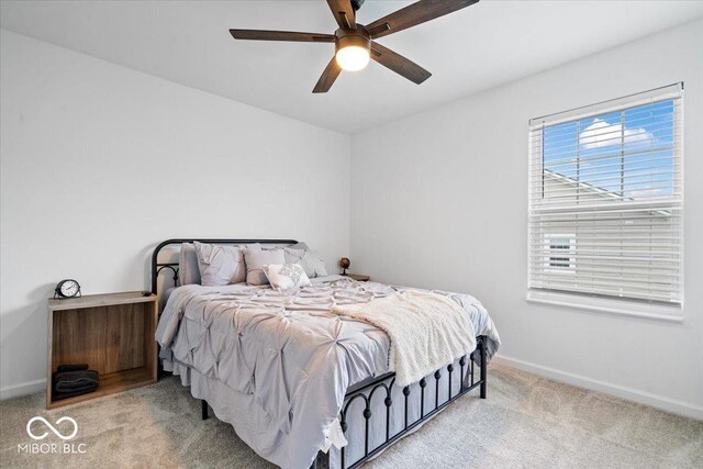 6507 W Whispering Way, Greenfield, IN 46140 - bedroom featuring light colored carpet, baseboards, and a ceiling fan