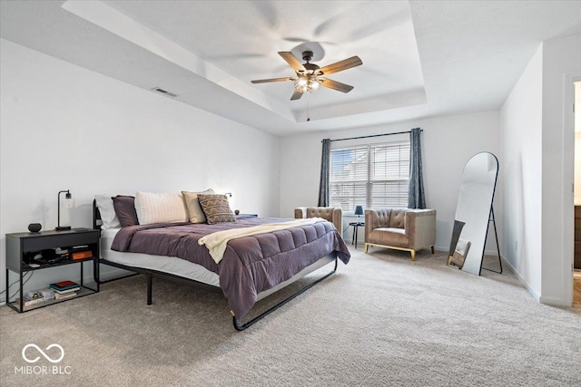6507 W Whispering Way, Greenfield, IN 46140 - carpeted bedroom with a tray ceiling, a ceiling fan, and baseboards