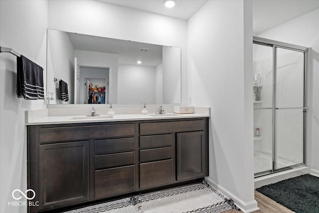 6507 W Whispering Way, Greenfield, IN 46140 - full bath with a stall shower, double vanity, baseboards, and wood finished floors