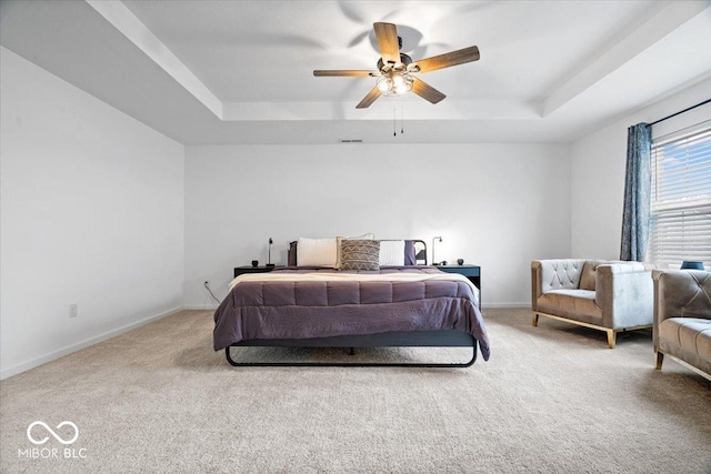 6507 W Whispering Way, Greenfield, IN 46140 - carpeted bedroom featuring a raised ceiling, baseboards, and ceiling fan
