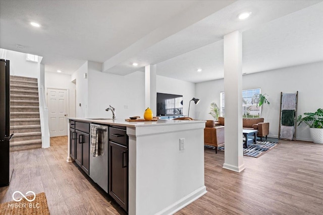 6507 W Whispering Way, Greenfield, IN 46140 - kitchen featuring open floor plan, light wood-style floors, a kitchen island with sink, light countertops, and recessed lighting