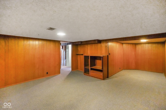 6133 Ashway Ct, Indianapolis, IN 46224 - finished below grade area featuring carpet, wood walls, and a textured ceiling