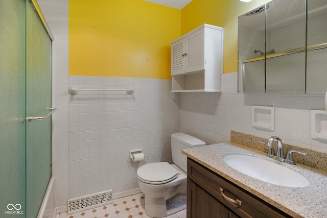 6133 Ashway Ct, Indianapolis, IN 46224 - bathroom featuring tile walls, vanity, wainscoting, and bath / shower combo with glass door