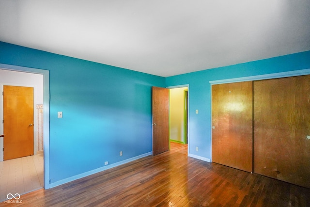 6133 Ashway Ct, Indianapolis, IN 46224 - unfurnished bedroom featuring wood finished floors and a closet