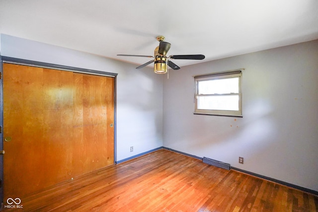 6133 Ashway Ct, Indianapolis, IN 46224 - unfurnished bedroom with a closet, wood finished floors, and a ceiling fan