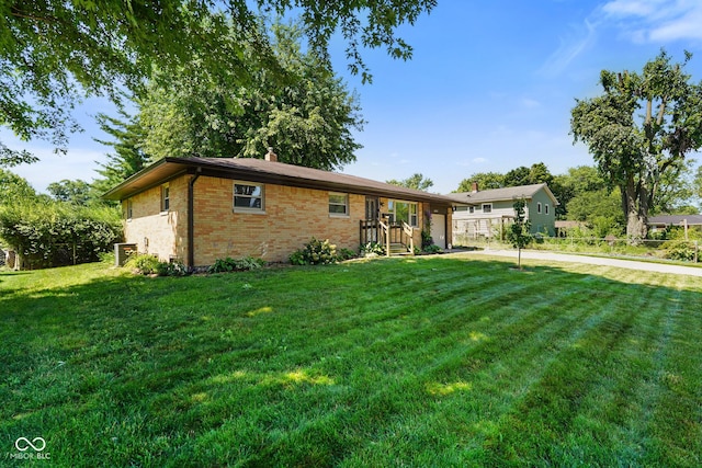 6133 Ashway Ct, Indianapolis, IN 46224 - ranch-style home with brick siding, a front yard, a garage, and driveway