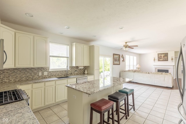 2096 Whitetail Ct, Avon, IN 46123 - kitchen featuring light tile patterned floors, healthy amount of natural light, open floor plan, appliances with stainless steel finishes, and recessed lighting