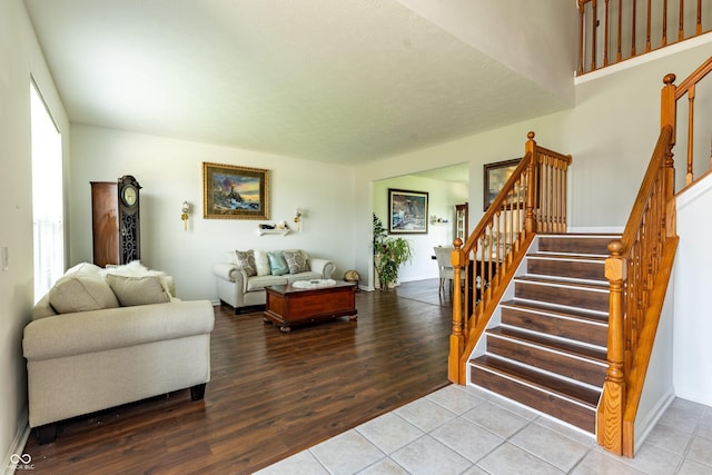 2096 Whitetail Ct, Avon, IN 46123 - living area with stairway, wood finished floors, and baseboards