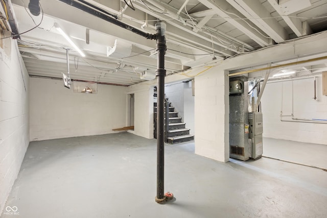2164 E Raymond St, Indianapolis, IN 46203 - unfinished below grade area featuring heating unit, stairway, and concrete block wall