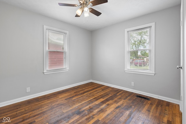 2164 E Raymond St, Indianapolis, IN 46203 - unfurnished room with healthy amount of natural light, dark wood-style floors, baseboards, and a ceiling fan