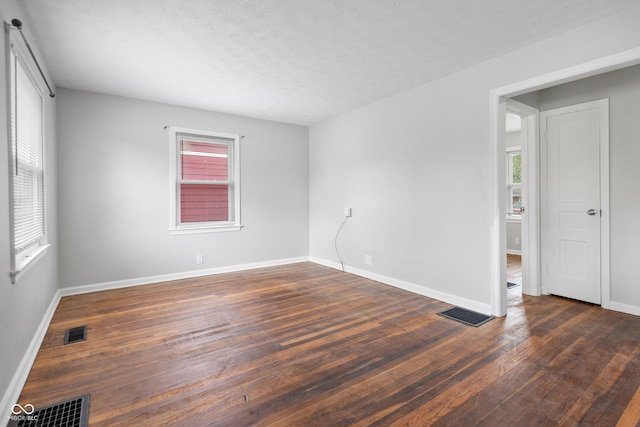 2164 E Raymond St, Indianapolis, IN 46203 - unfurnished room featuring plenty of natural light, dark wood-style floors, and baseboards