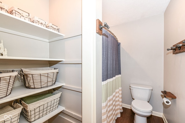 6580 Kings Ct, Avon, IN 46123 - bathroom with wood finished floors and a shower with shower curtain