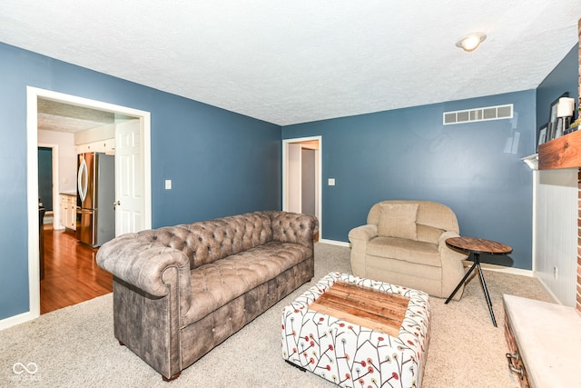 6580 Kings Ct, Avon, IN 46123 - carpeted living room with a textured ceiling and a brick fireplace