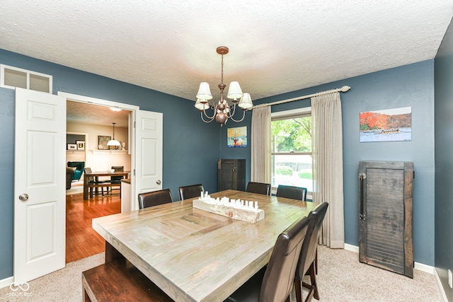 6580 Kings Ct, Avon, IN 46123 - dining room featuring a chandelier, a textured ceiling, and light carpet