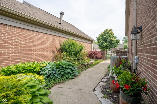 131 Olde Mill Bay, Indianapolis, IN 46260 - view of side of home featuring brick siding and a shingled roof