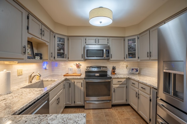 131 Olde Mill Bay, Indianapolis, IN 46260 - kitchen with stainless steel appliances, a sink, backsplash, and light stone counters