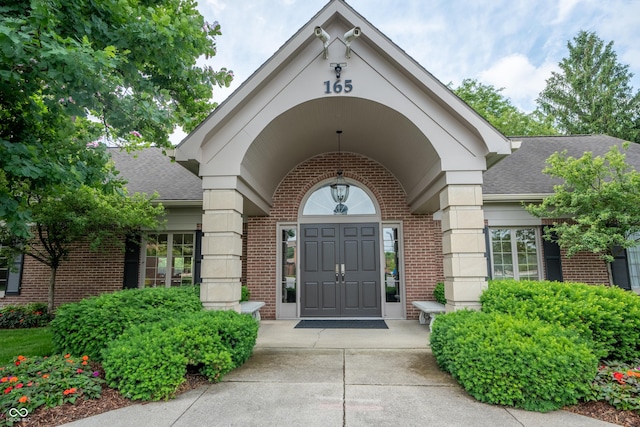 131 Olde Mill Bay, Indianapolis, IN 46260 - doorway to property featuring brick siding and a shingled roof