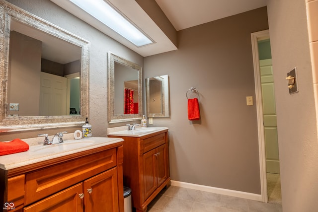 131 Olde Mill Bay, Indianapolis, IN 46260 - bathroom with two vanities, tile patterned flooring, and baseboards