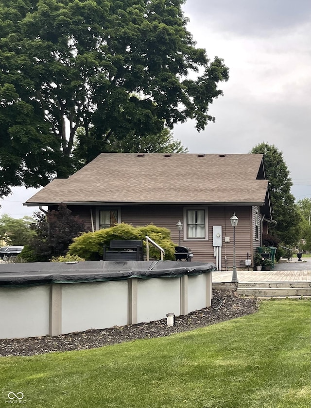 9467 N Michigan Rd, Fairland, IN 46126 - back of house featuring a covered pool, a yard, and a shingled roof