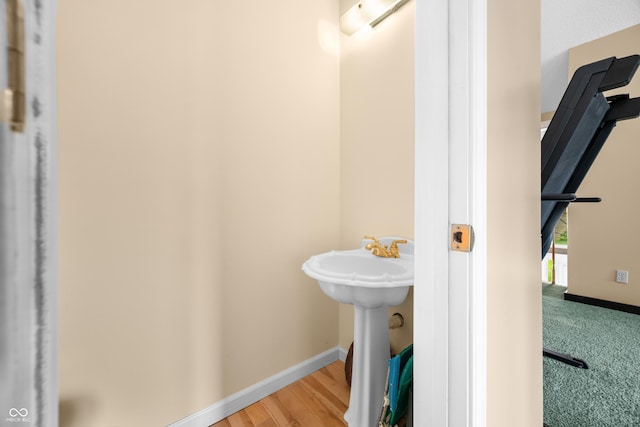5439 E Kinderhook Rd, Scottsburg, IN 47170 - bathroom featuring baseboards, a sink, and wood finished floors