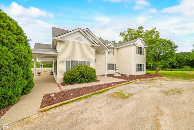 5439 E Kinderhook Rd, Scottsburg, IN 47170 - view of front of property featuring dirt driveway, a carport, and a shingled roof